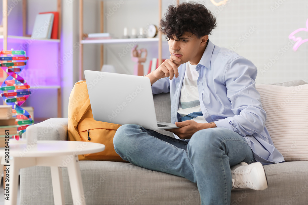 Male student studying with laptop at home Male student studying with laptop at home