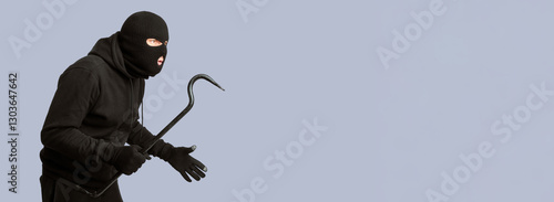 Принти на полотні Portrait of disguised looter holding crowbar and looking at copy space, isolated