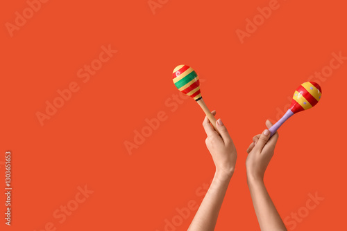 Female hands holding maraca...