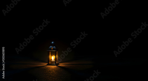 Illuminated Lantern Burning Brightly on Ground in a Dark Background