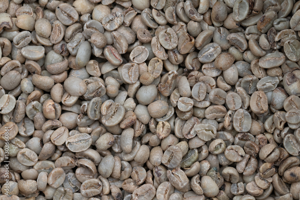 Close-up of green, unroasted coffee beans from above. Close-up of green, unroasted coffee beans from above.