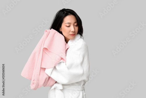 Young Asian woman wiping ha...