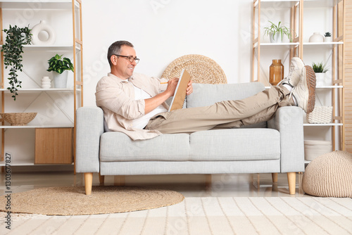 Old man lying on sofa and w...