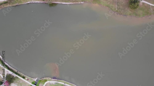 aerial view of a large lake, within a neighborhood