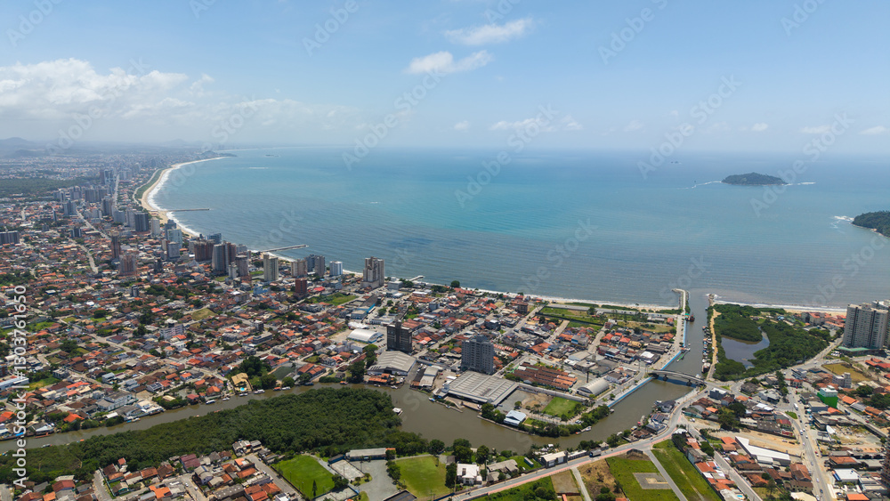 Fototapeta premium Panoramic aerial view of Balneário Piçarras, a coastal city in southern Brazil, on a sunny day, highlighting its long shoreline and urban landscape.