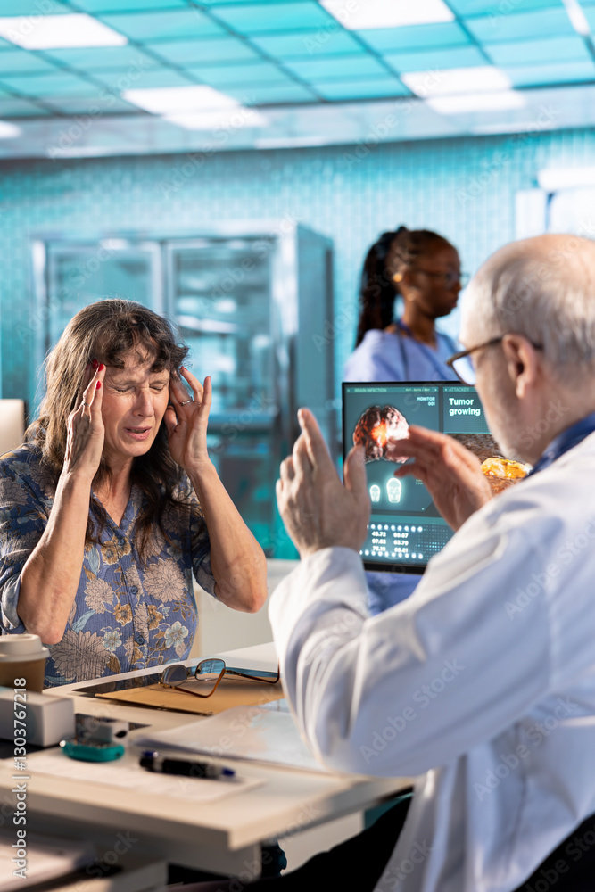 Fototapeta premium Old woman patient suffers from a painful migraine and asks for advice at checkup with medic, general practitioner recommending a treatment to relieve pain and ease the inflammation. Health insurance.