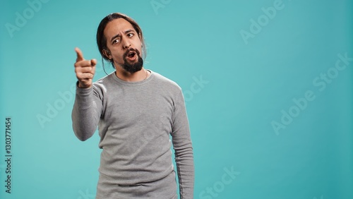 Canvas Print Angry man fighting with friend over debacle, putting blame on him, isolated over studio background