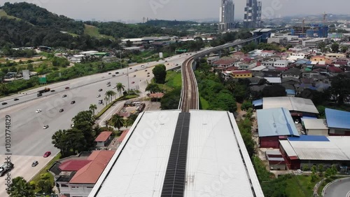 Aerial view of a monorail approaching a monorail station.