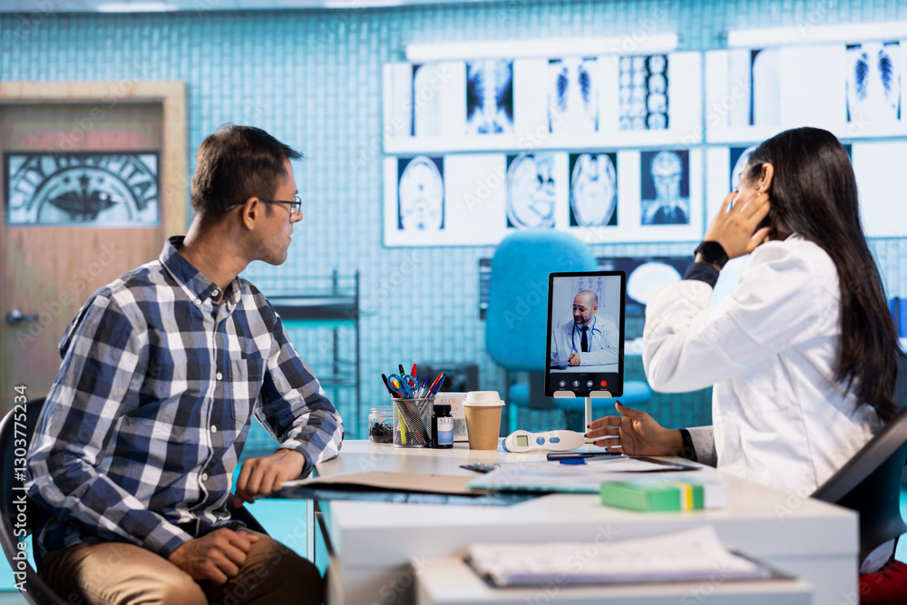 Fototapeta premium Indian physician entering a video call with expert to discuss diagnostic report, asking the specialist for a second opinion on remote videoconference. Doctors meeting online for telehealth.