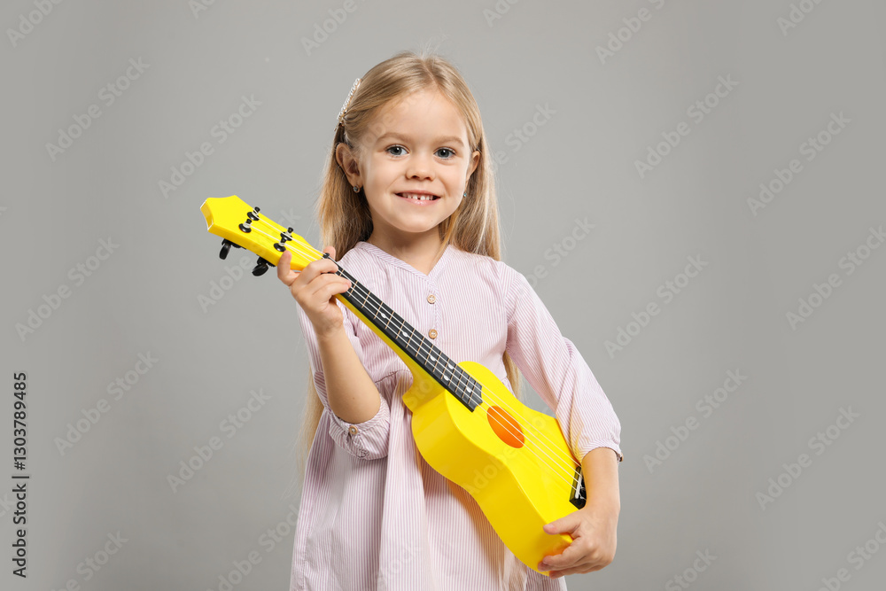 Little girl with ukulele on gray background Little girl with ukulele on gray background