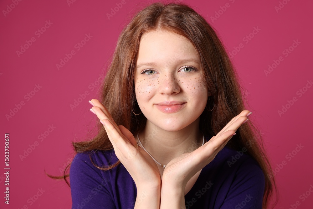 Beautiful teenage girl with freckles on pink background Beautiful teenage girl with freckles on pink background