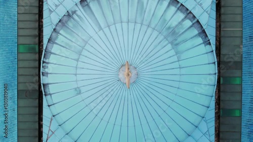 Aerial top down view of a mosque showing unique architecture with blue roofs