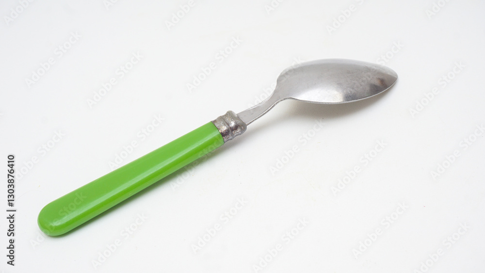 Back side of modern stainless steel spoon with green handle isolated on white background Back side of modern stainless steel spoon with green handle isolated on white background