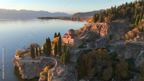 Aerial drone video of Saint John at Kaneo church overlooking Lake Ohrid in North Macedonia at sunset 