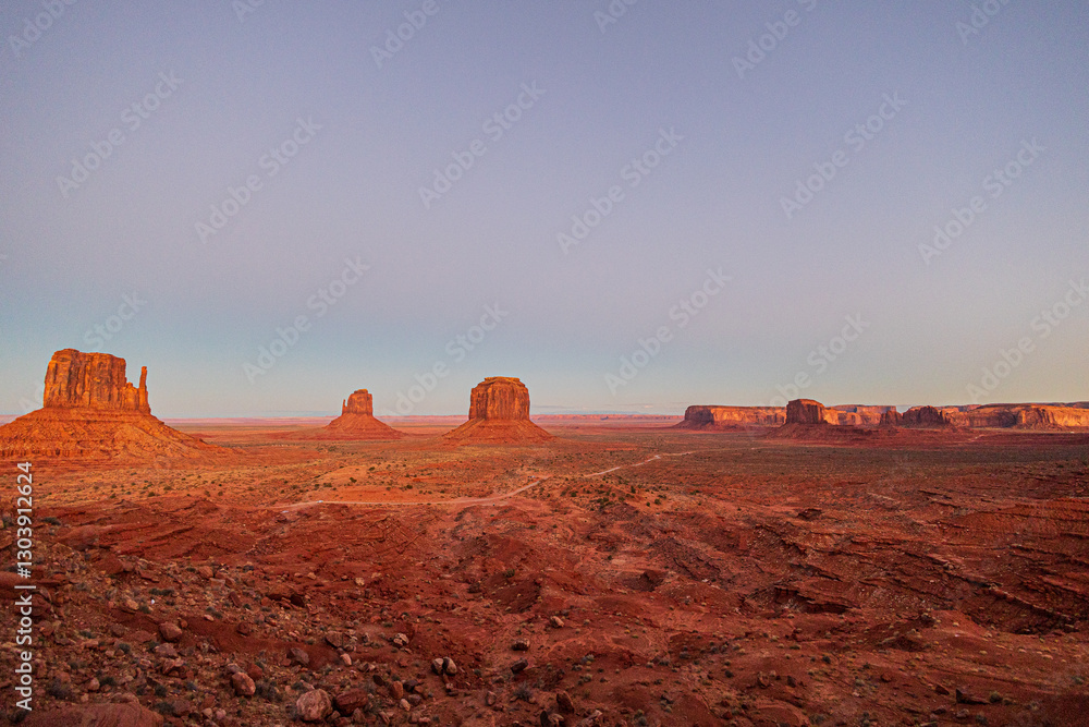 Monument Valley glows orange as the sun starts to set in the late evening. Monument Valley glows orange as the sun starts to set in the late evening.