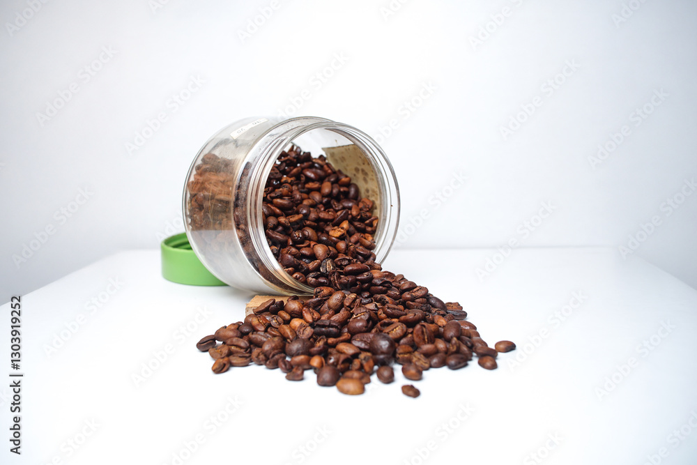 Coffee beans on a glass jar isolated on a white background Coffee beans on a glass jar isolated on a white background