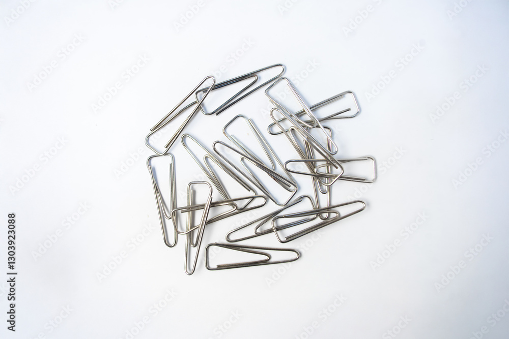 Fototapeta premium Isolated grey papper clips on a white background