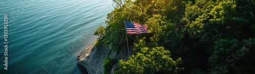 An American flag is flying on the cliff overlooking Lake Michigan, an aerial view captured by a drone.