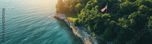 An American flag is flying on the cliff overlooking Lake Michigan, an aerial view captured by a drone.