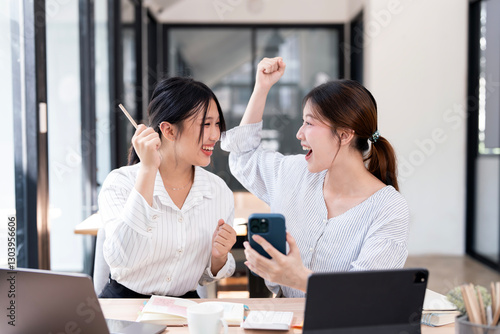 Two young startup businesswomen doing a celebrating their success in home office