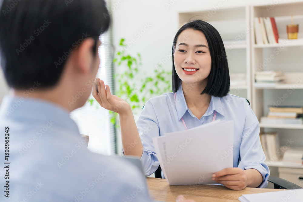 Successful job interview in a modern office setting between a hiring manager and an applicant Successful job interview in a modern office setting between a hiring manager and an applicant