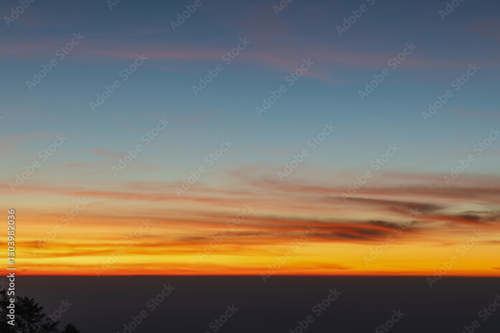 Obraz premium Heaven at early morning with copy space. Smooth orange blue gradient of dawn sky.Sunset, sunrise backdrop.Natural colors. Orange and red dramatic colors.