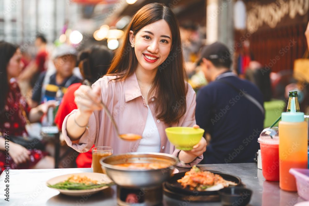 Traveler woman enjoy eating street food spicy thai tasty menu travel at chinatown Yaowarat, Bangkok, Thailand Traveler woman enjoy eating street food spicy thai tasty menu travel at chinatown Yaowarat, Bangkok, Thailand