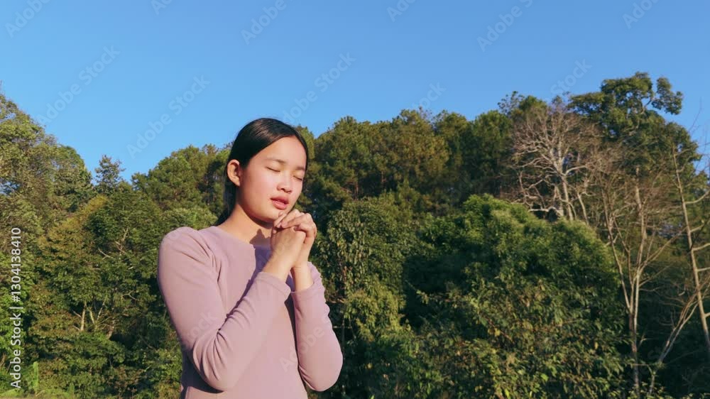 Silhouette portrait of teens girl praying against the background of the sun sky. Silhouette portrait of teens girl praying against the background of the sun sky.