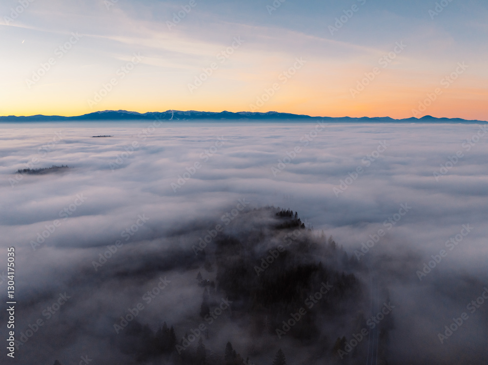 Obraz premium Misty morning in Liptov region with High Tatras mountains around. Liptovsky Mikulas landspace, slovakia.