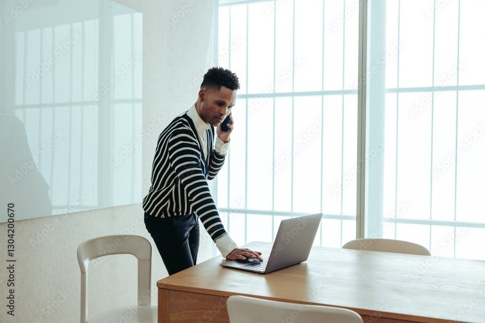 Fototapeta premium Executive multitasking with technology in a modern office setting