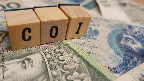 Polish PLN banknotes and COI inscription made of letter cubes. Savings bonds indexed to inflation