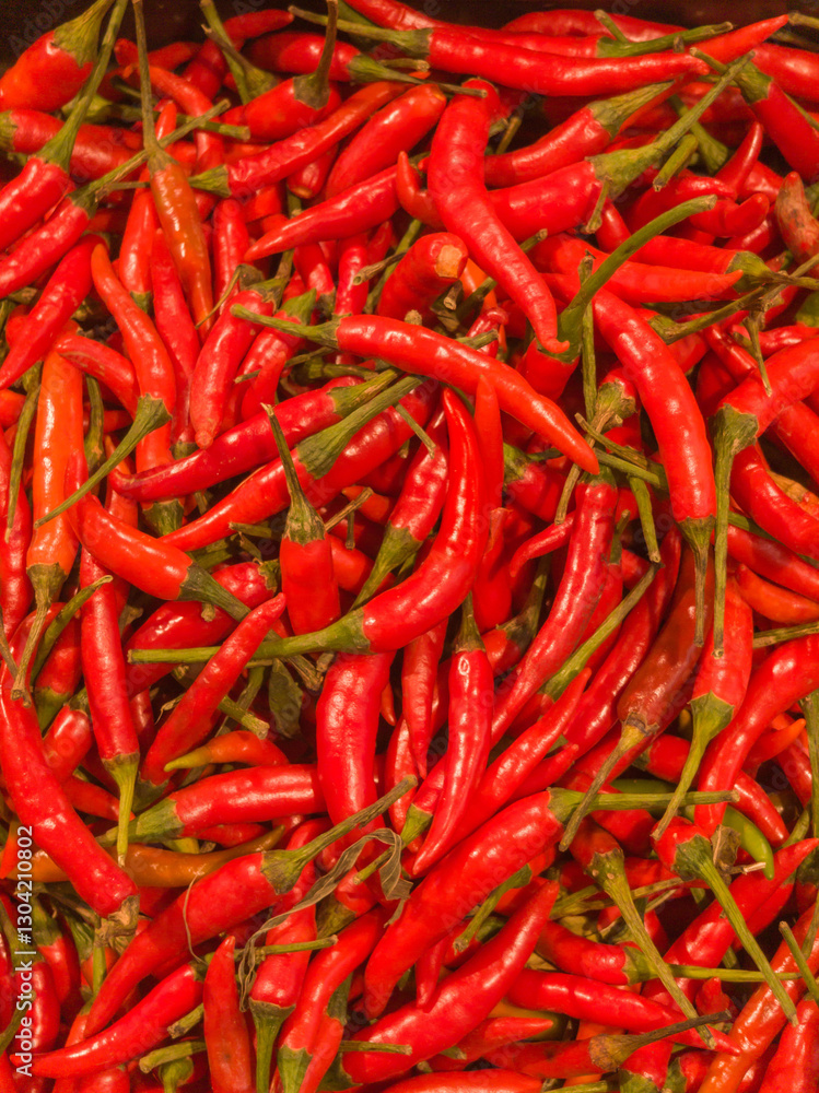 Pile of fresh chilli in supermarket. Close up of spicy food in bright red. Pile of fresh chilli in supermarket. Close up of spicy food in bright red.