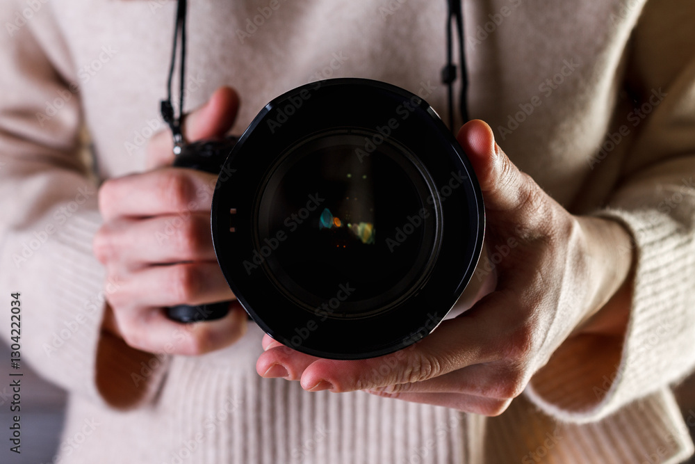 Professional photographer woman holding camera in your hands.