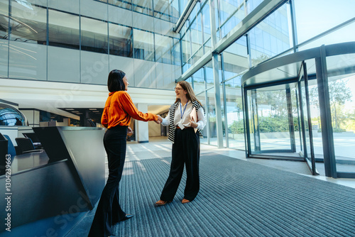 Welcome meeting for new hire in modern office lobby