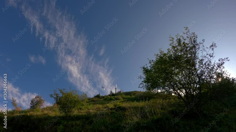 low angle view paragliders soaring above lush greenery bright blue sky