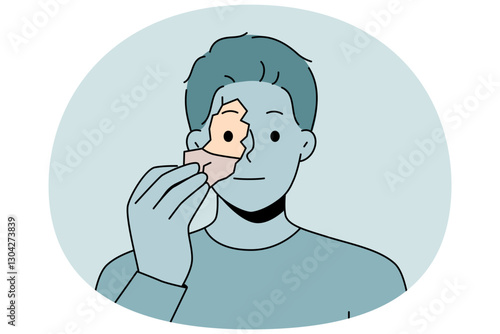 Man tears off fragment of own face to change shell and get rid of psychological problems. Unemotional guy needs self-renewal to improve psychological health and eliminate depressive thoughts