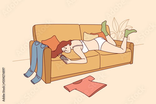 Lazy woman in underwear lies on sofa and uses phone, not paying attention to chaos in apartment. Scattered things around lazy girl who suffers from procrastination and does not want to clean room.