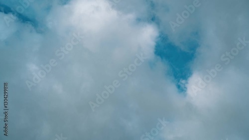 Flying white clouds in the blue sky during the day. 4K time lapse 