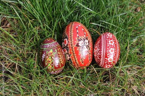 Traditional hand-dyed and hand-painted Easter eggs on the green grass in Poland called pisanka or kroszonka or kraszonka photo