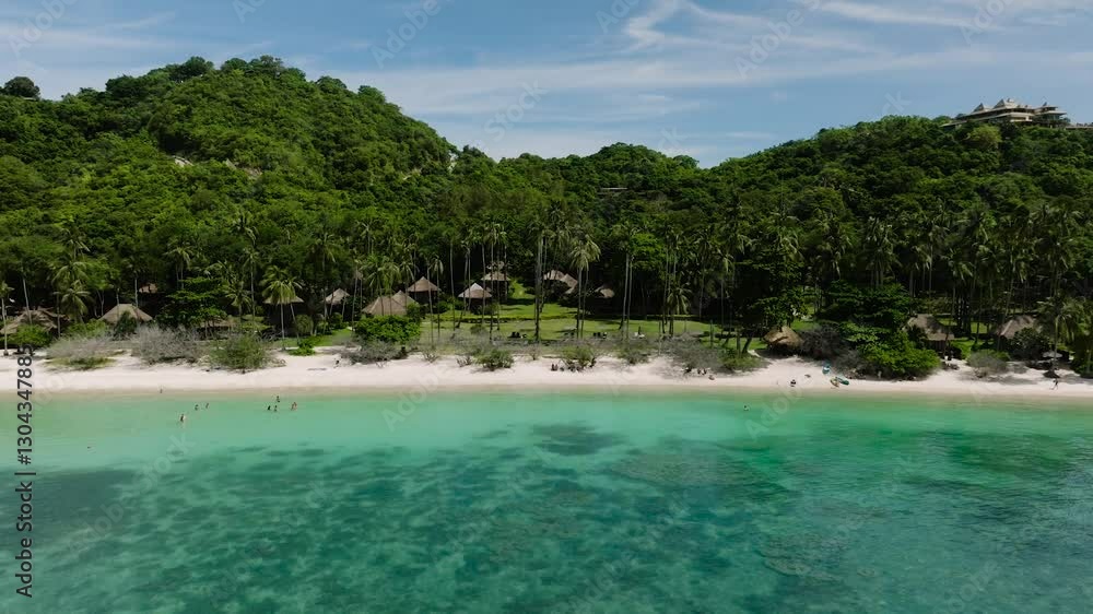 White sandy beach surrounded by tropical vegetation and clear turquoise water under a blue sky. Shark Bay. Koh Tao, Thailand. White sandy beach surrounded by tropical vegetation and clear turquoise water under a blue sky. Shark Bay. Koh Tao, Thailand.