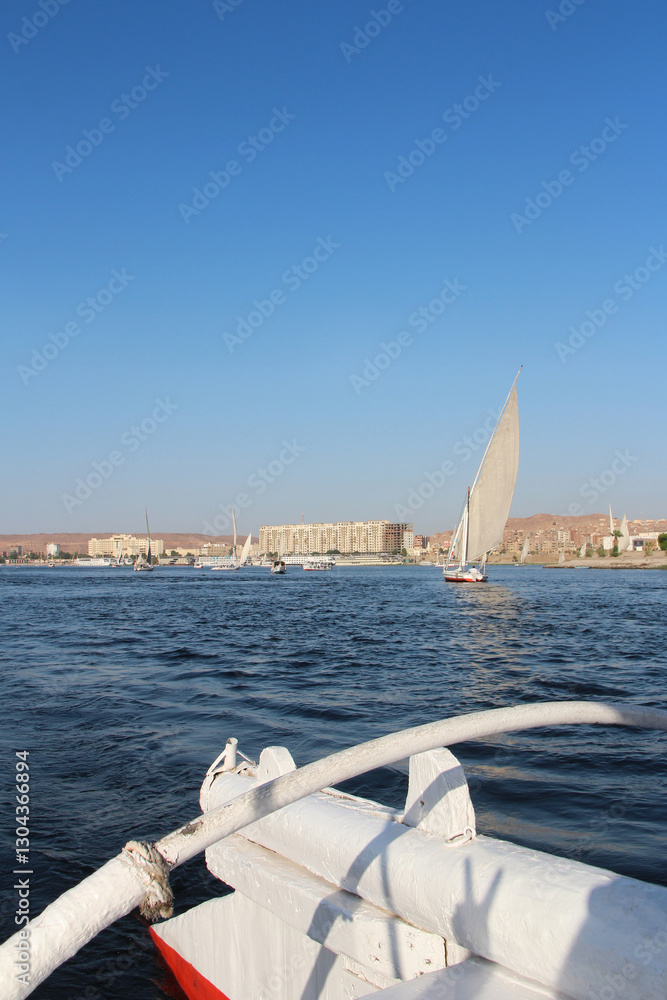 Obraz premium Felucca sailing on Nile River in a sunny afternoon at Aswan, Egypt