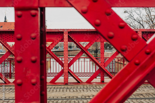 Close-up of a red riveted bridge in Wroclaw, showcasing early 20th-century architecture