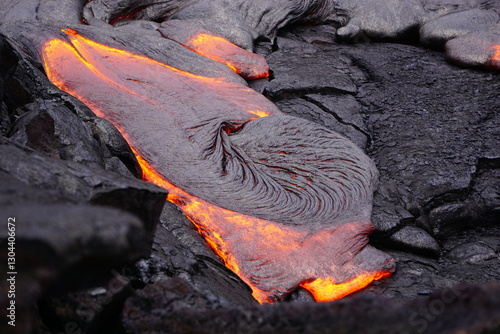Detail of hot magma flowing over old lava field