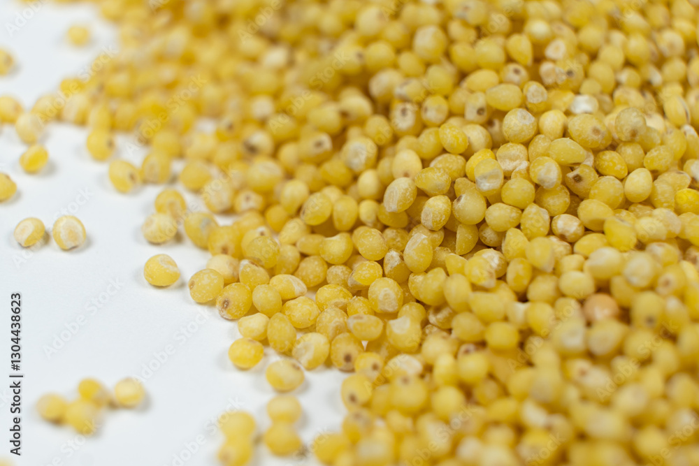 Uncooked organic raw millet grains close-up background Uncooked organic raw millet grains close-up background