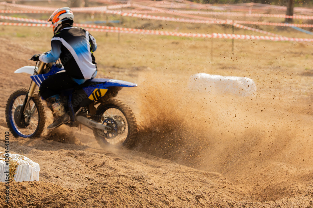 Selective focus details of debris in a motocross race.Professional motocross rider creates a huge cloud of dust.Enduro bike rider on action, dirt ride and muddy road.Motocross extreme sport. Selective focus details of debris in a motocross race.Professional motocross rider creates a huge cloud of dust.Enduro bike rider on action, dirt ride and muddy road.Motocross extreme sport.
