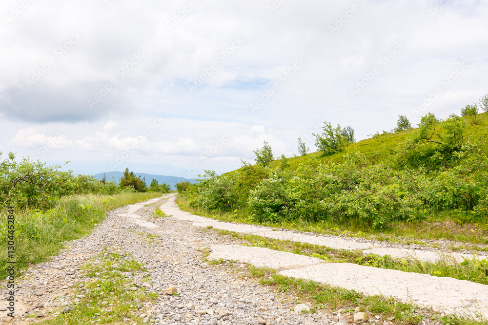 old concrete mountain road. outdoor adventure. path through smooth mount on a cloudy day. travel ukraine. scenic wanderlust in europe