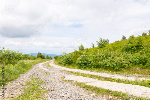 Obraz na płótnie old concrete mountain road. outdoor adventure. path through smooth mount on a cloudy day. travel ukraine. scenic wanderlust in europe w salonie