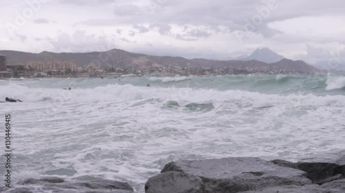Wallpaper Mural Beginner surfers in wetsuits try to catch a wave on a board in the sea. Torontodigital.ca