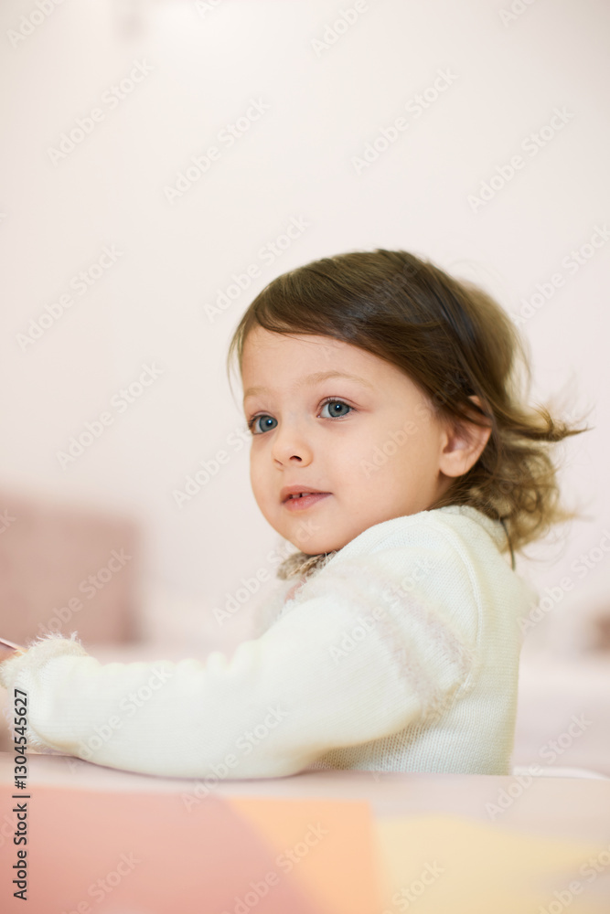 little child girl sitting at the table at home, child development. little child girl sitting at the table at home, child development.