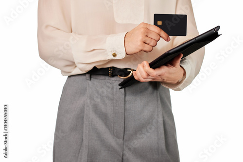 woman in white blouse and grey pants using credit card and digital tablet on white background
